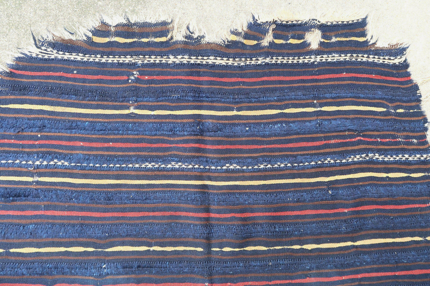 Handmade antique Berber handira from Morocco, Outat El Haj region. This piece is from the end of 19th century in original condition, it has some holes and wears. The kilim is collectible and made in wool.