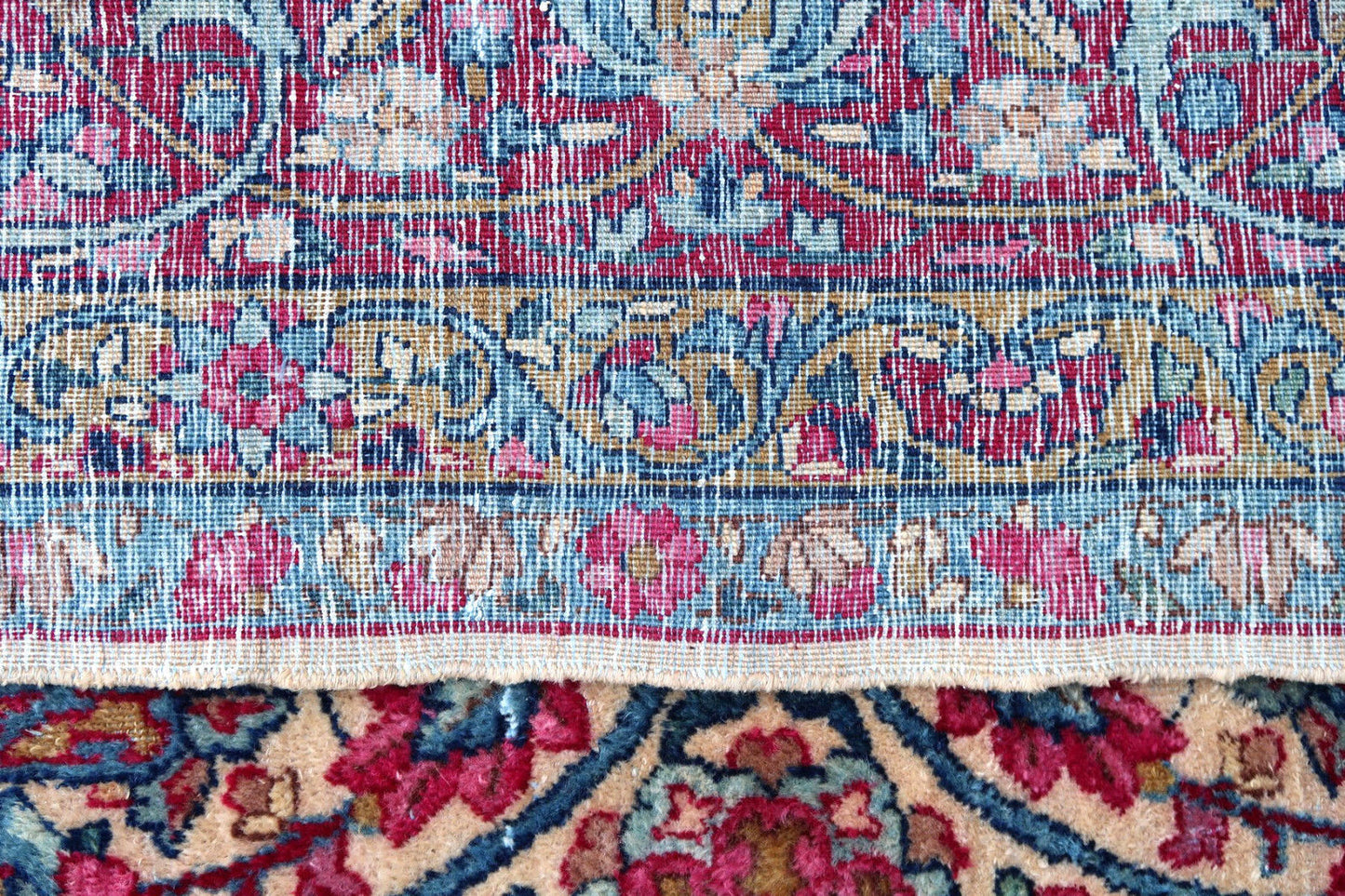 Handmade antique fragment of Persian Kerman rug in traditional busy floral design. The fragment is in original good condition, it is from the beginning of 20t century.
