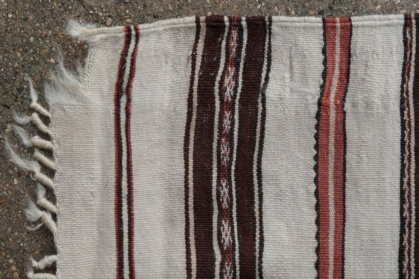 Handmade antique Moroccan Berber kilim from the middle Atlas region. The flatweave is from the beginning of 20th century in original condition, it has some signs of age.