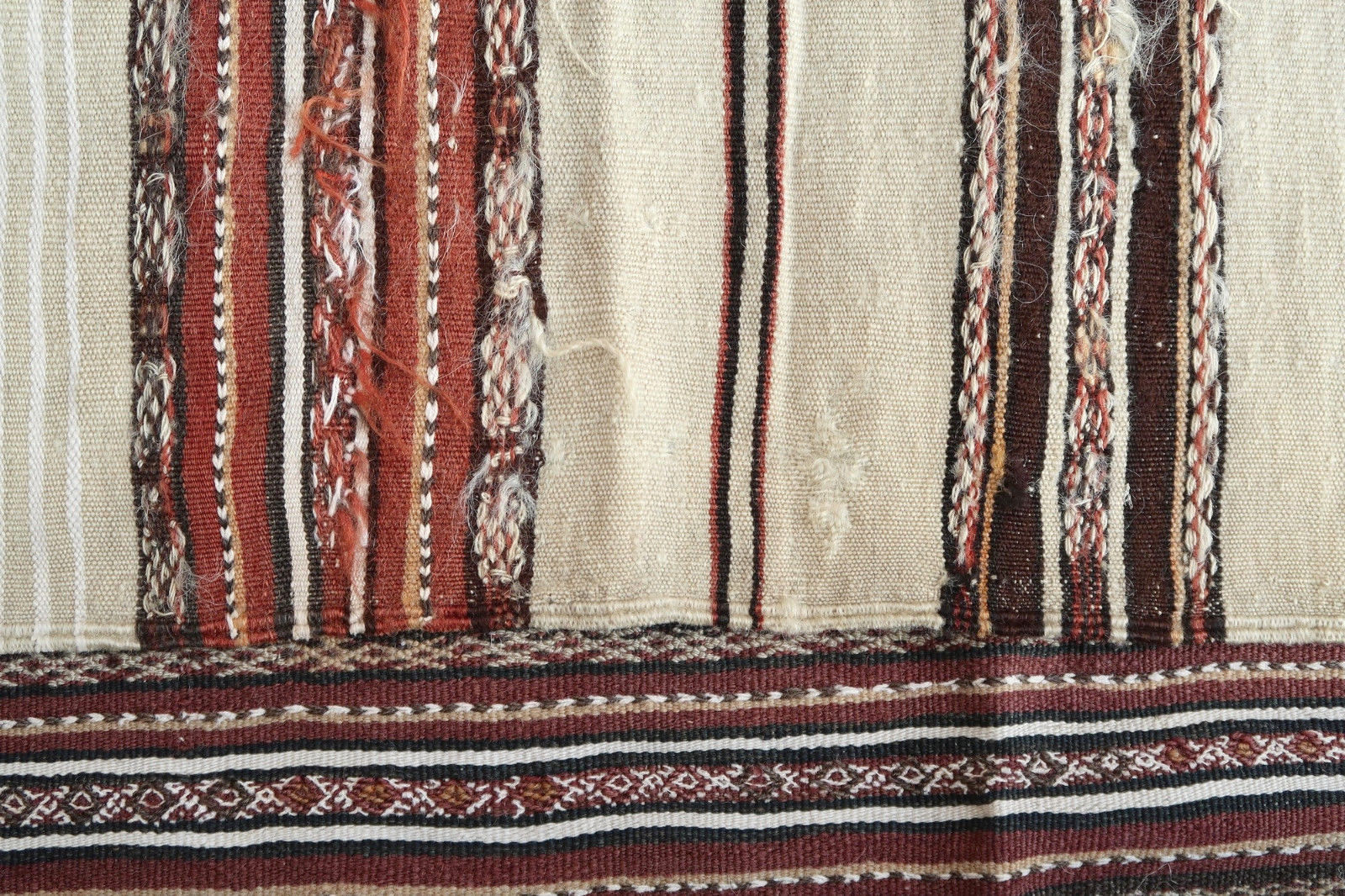 Handmade antique Moroccan Berber kilim from the middle Atlas region. The flatweave is from the beginning of 20th century in original condition, it has some signs of age.