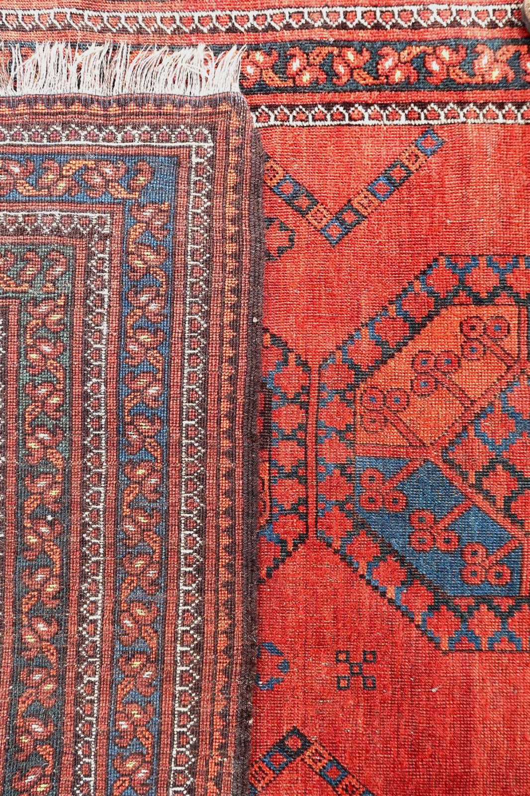 Handmade antique Afghan Baluch rug in traditional elephant feet design. The rug is from the beginning of 20th century in original condition, it has some low pile.