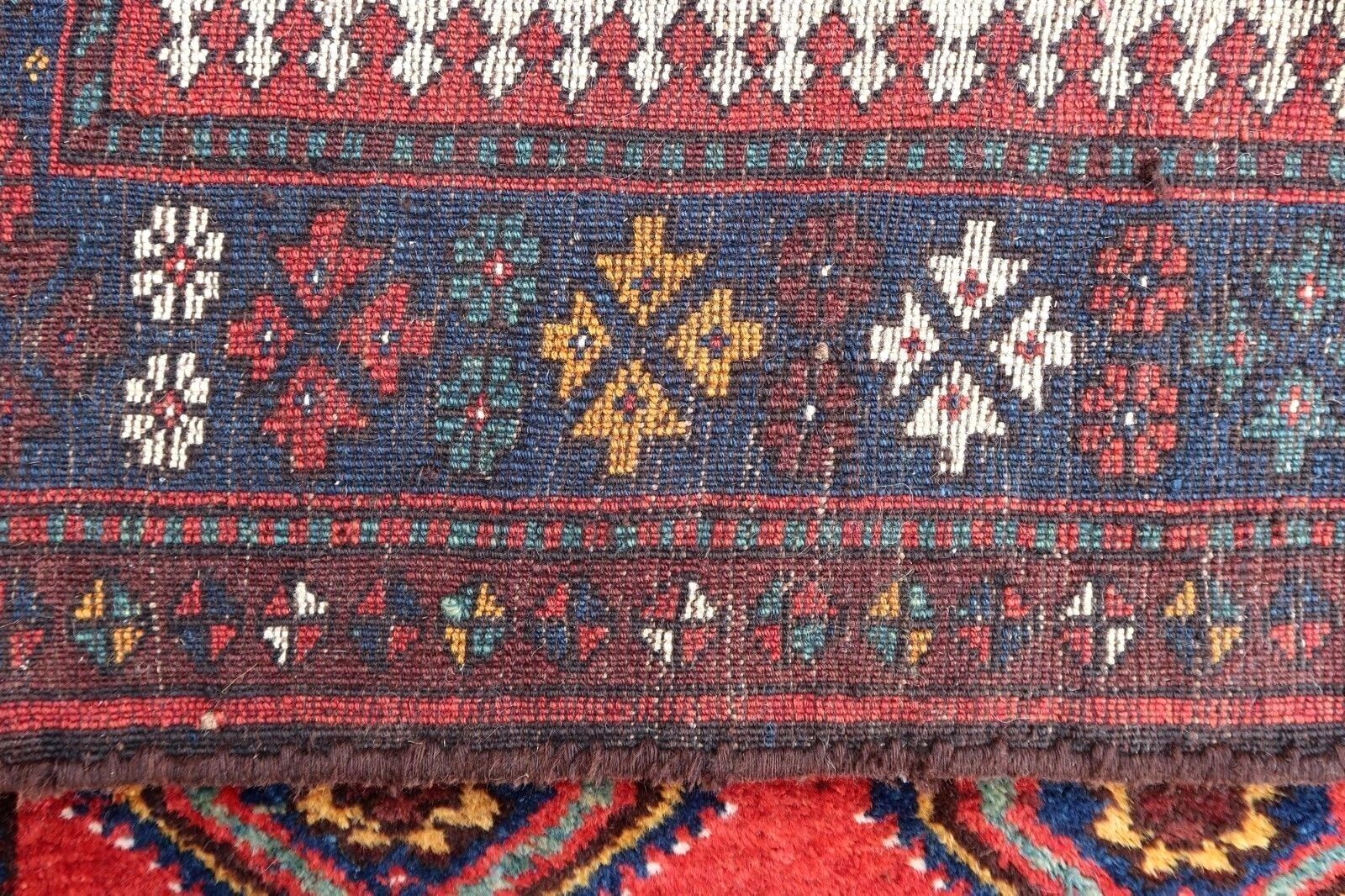 Handmade antique Persian Gashkai long rug in bright red color. The rug is from the beginning of 20th century in original good condition.