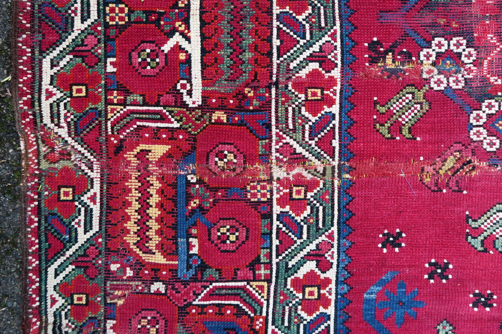 Handmade antique Algerian Berber rug in original condition, it has some signs of age and old restorations. This rug is from the beginning of 19th century made in crimson wool and tribal design.