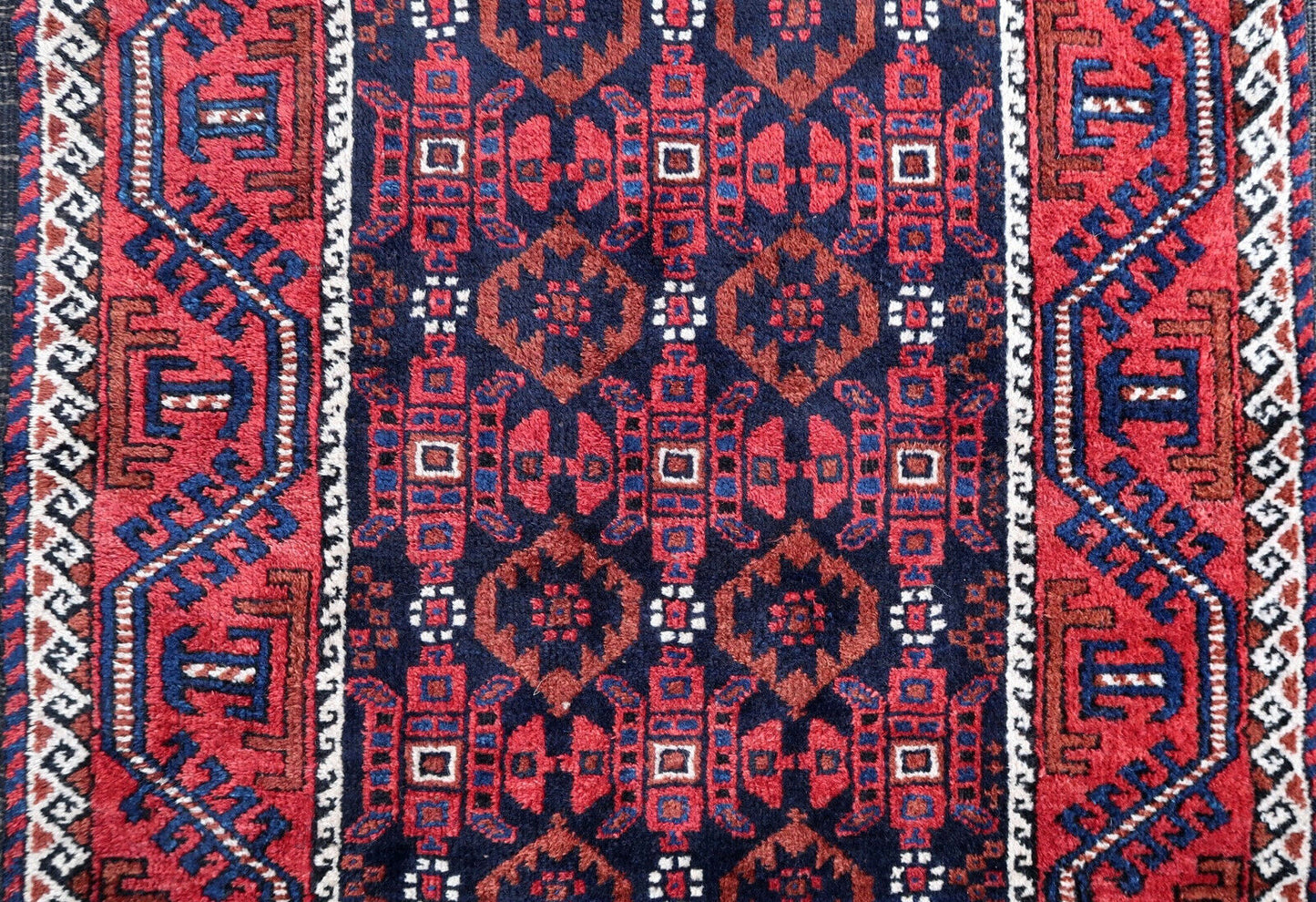 Handmade antique Baluch rug from Central Asia in original good condition. The rug is from the beginning of 20th century.