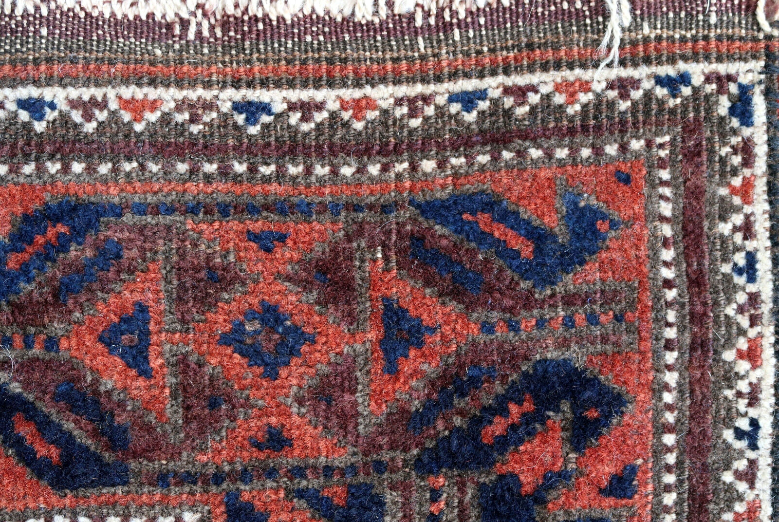 Handmade antique Baluch rug from Central Asia in original good condition. The rug is from the beginning of 20th century.