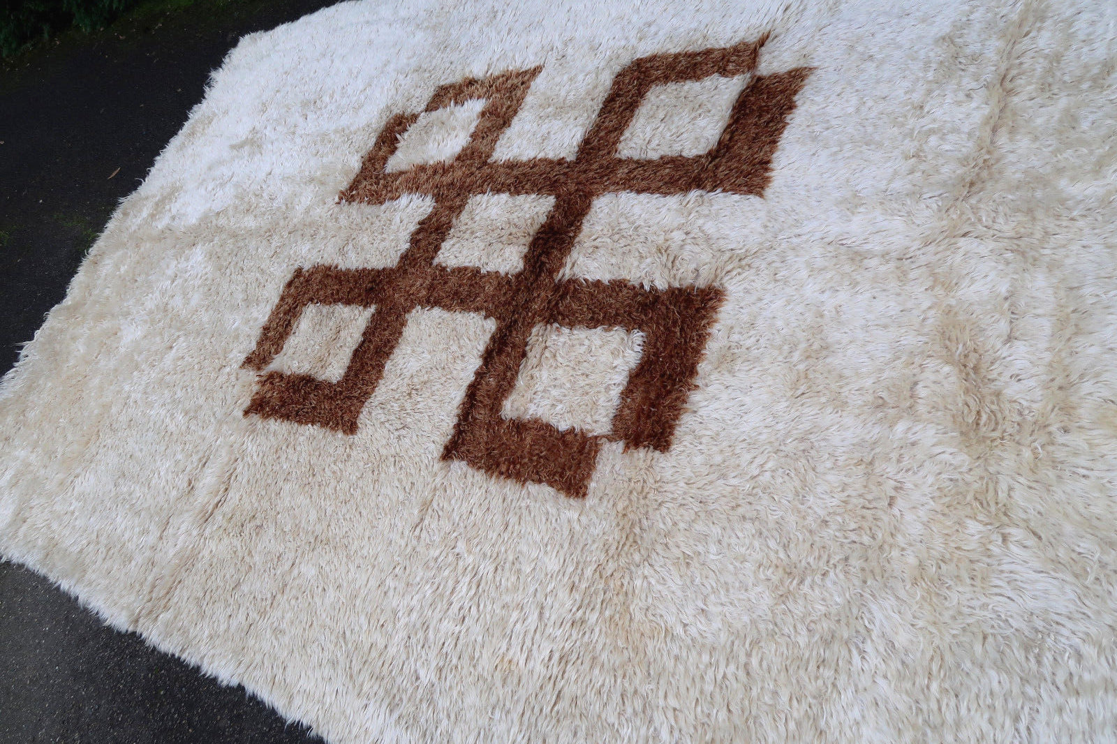 Handmade vintage rug from Madagascar in white and brown colors. The rug is from the end of 20th century in original good condition.