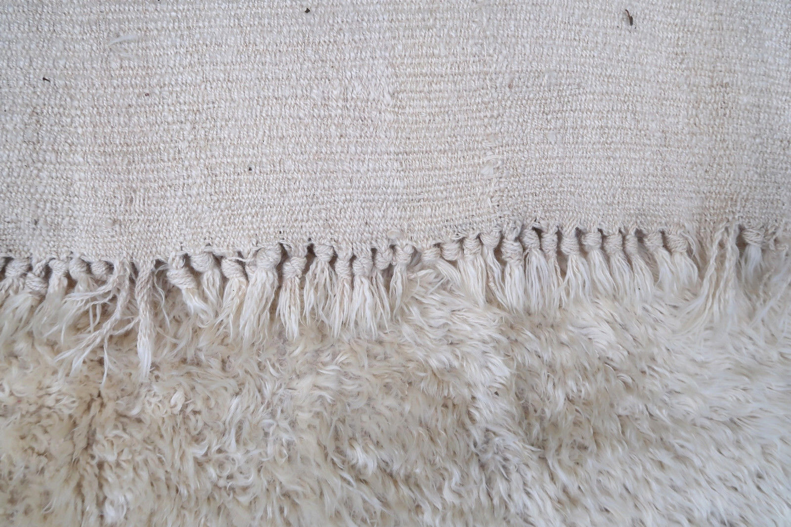 Handmade vintage rug from Madagascar in white and brown colors. The rug is from the end of 20th century in original good condition.