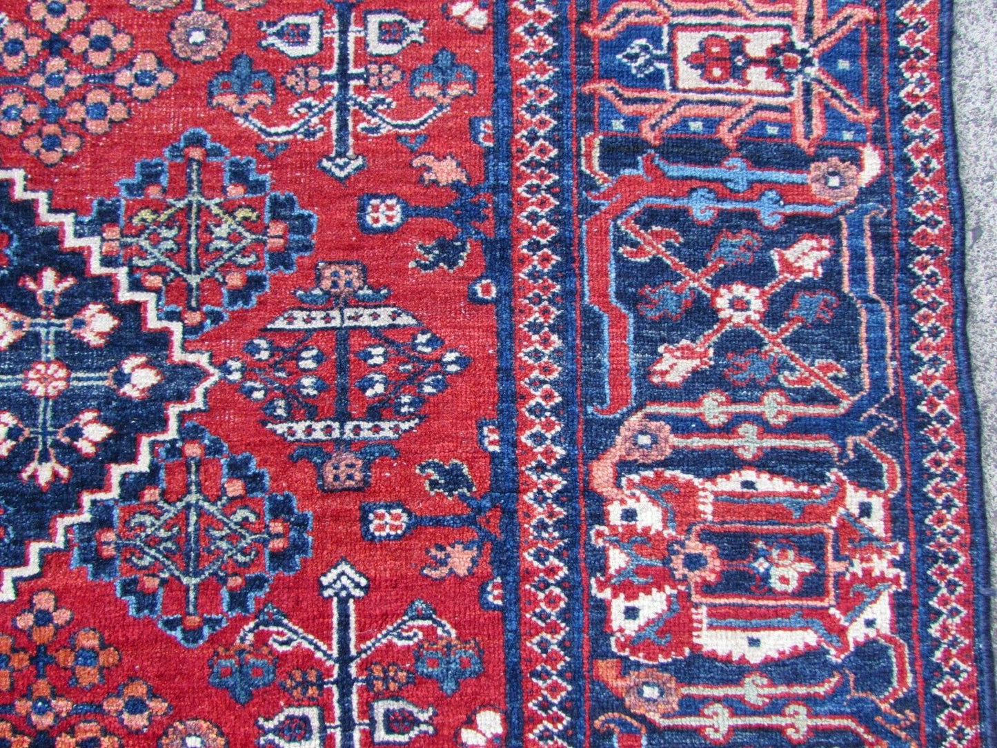 Handmade antique Persian Joshagan rug in bright red color. The rug is from the beginning of 20th century mostly in original good condition, it has some low pile