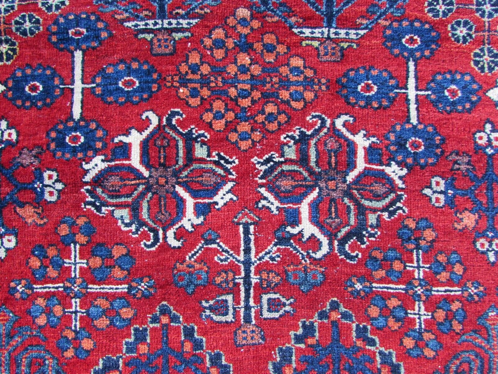 Handmade antique Persian Joshagan rug in bright red color. The rug is from the beginning of 20th century mostly in original good condition, it has some low pile