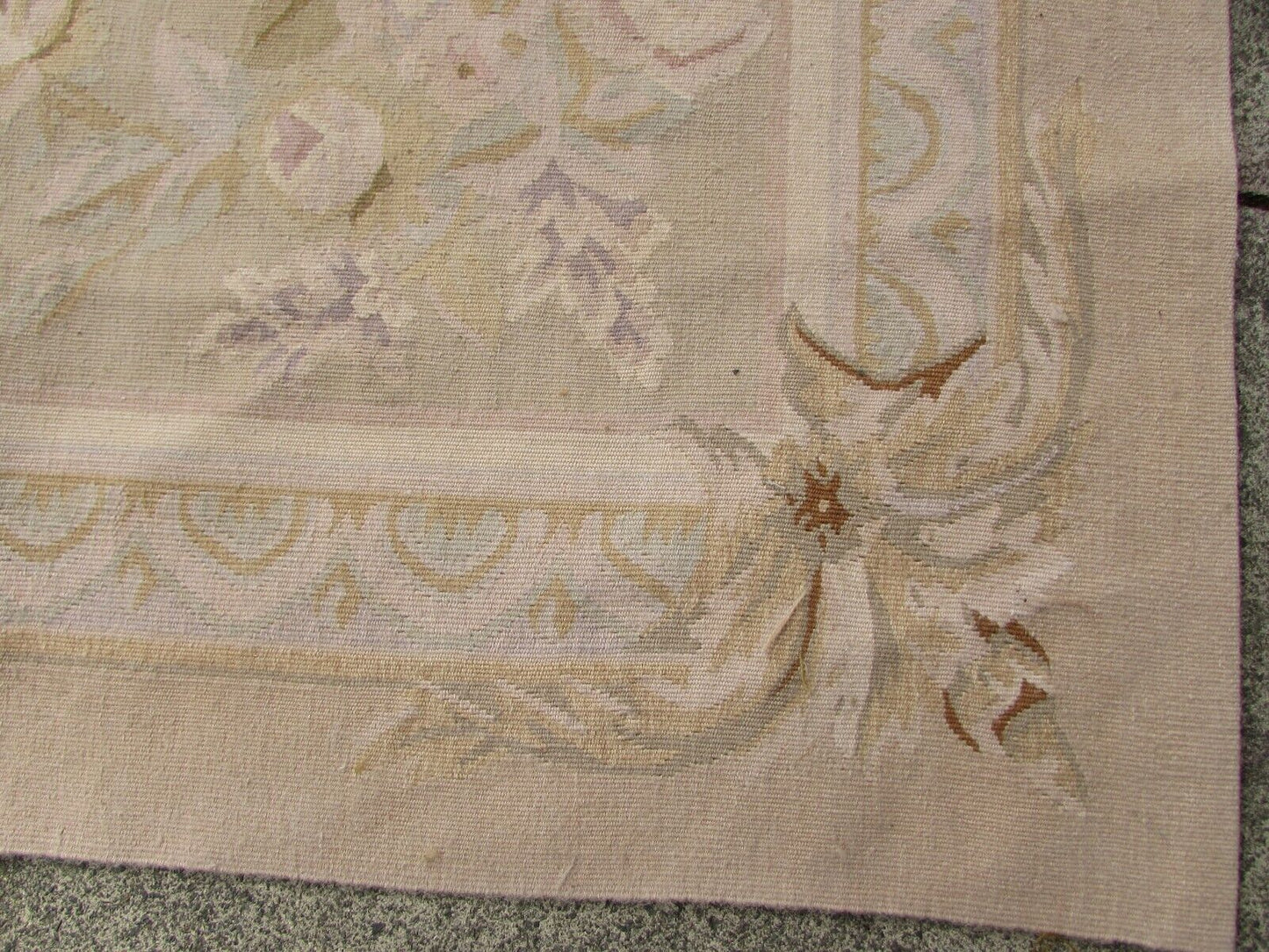 Handmade vintage French Aubusson rug in traditional design and pastel shades. The rug is from the end of 20th century in original good condition.