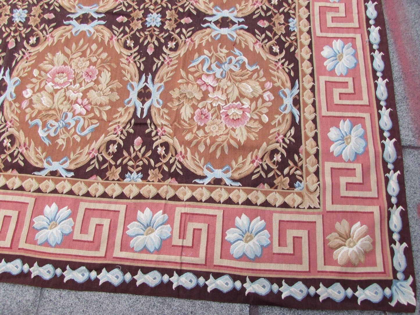 Handmade vintage French Aubusson rug in traditional design and burgundy shades. The rug is from the end of 20th century in original good condition.