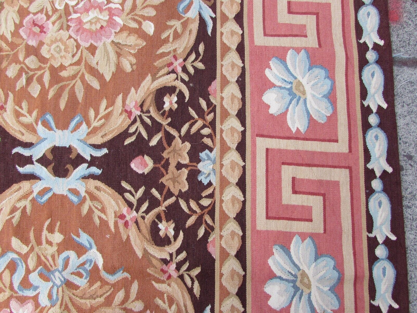 Handmade vintage French Aubusson rug in traditional design and burgundy shades. The rug is from the end of 20th century in original good condition.