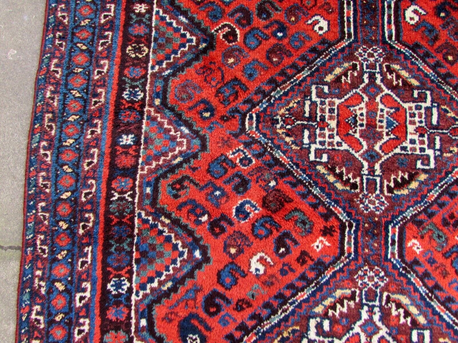 Handmade antique Persian Shiraz rug in traditional medallion design. The rug is from the beginning of 20th century in original good condition.