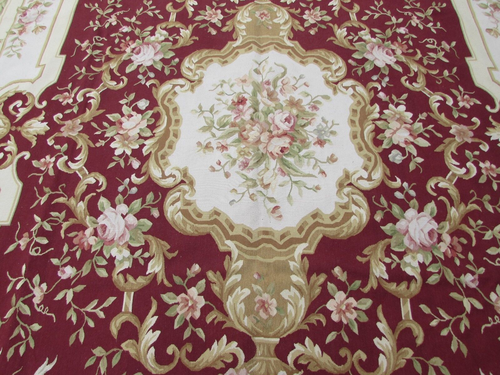 Handmade vintage French Aubusson rug in traditional floral design in burgundy and beige shades. This rug has been made in the end of 20th century and in original good condition.