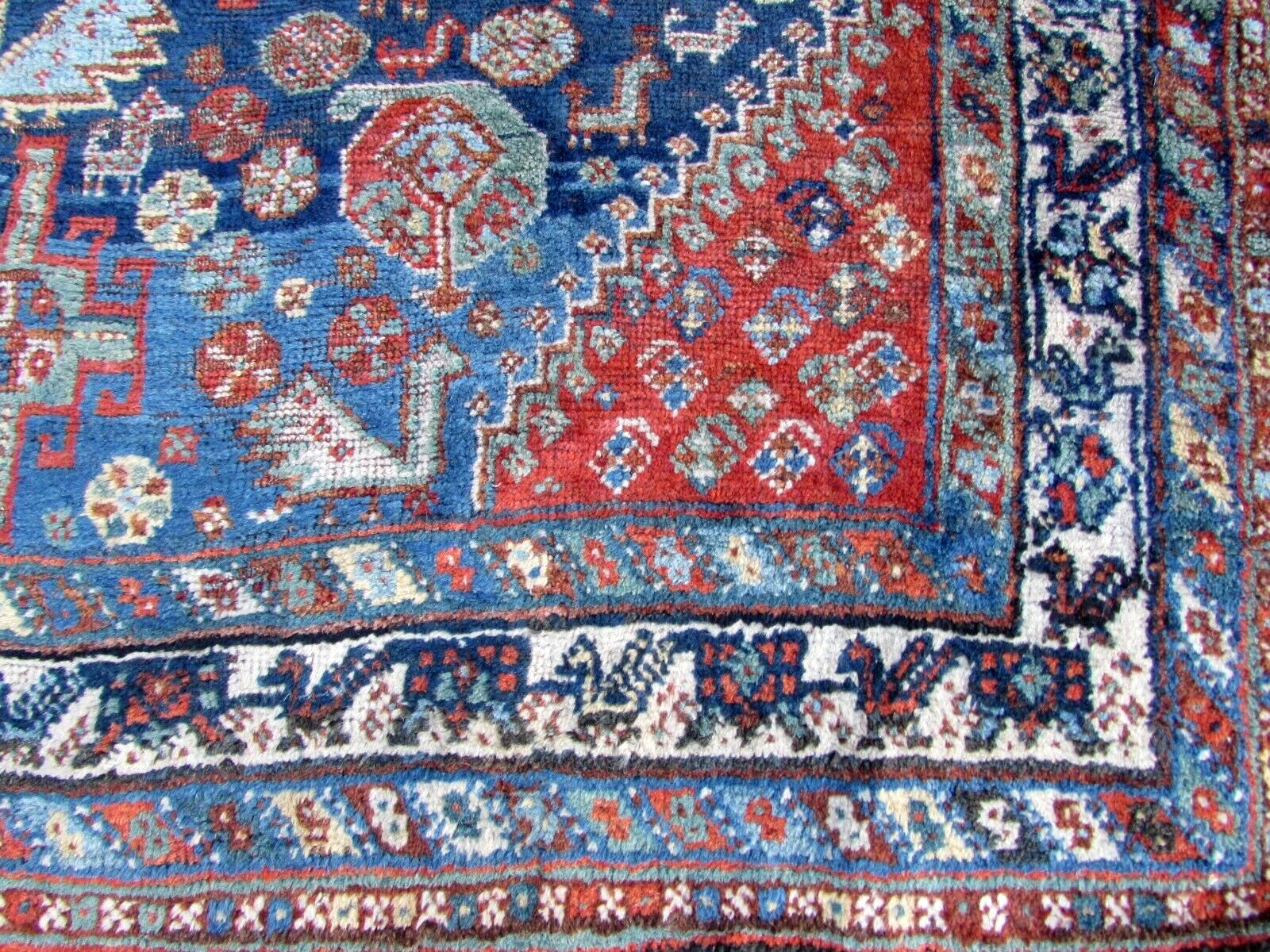 Detailed view of the vibrant red, blue, and white colors used in Shiraz style rug.