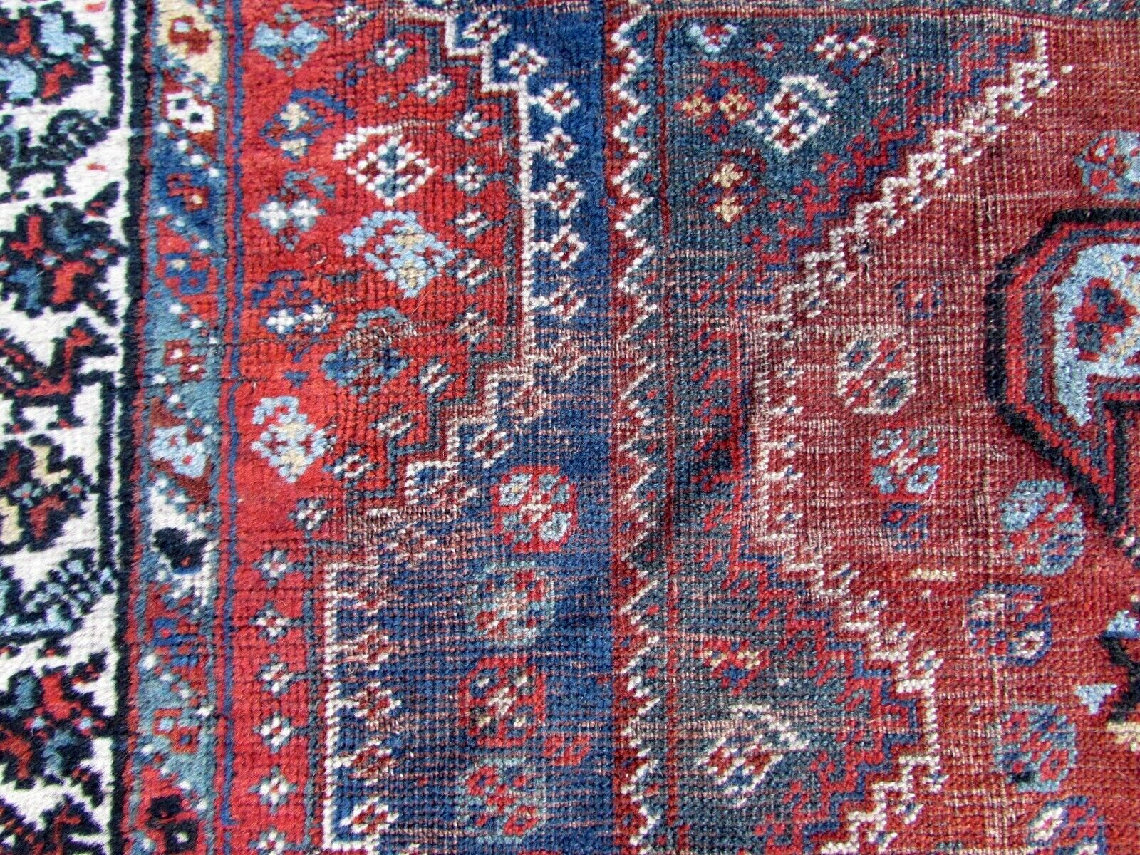 Detailed view of hand-knotted wool fibers in vintage rug