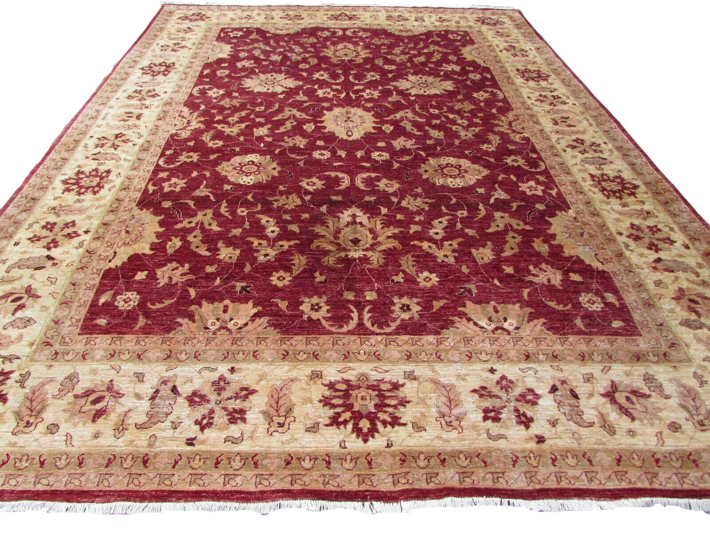 Handmade vintage Afghan Zigler rug from the 1980s made of high-quality wool with a classic Zigler pattern and background colors of ruby, beige, and olive measuring 9.7' x 12.8' (297cm x 393cm) in original good condition