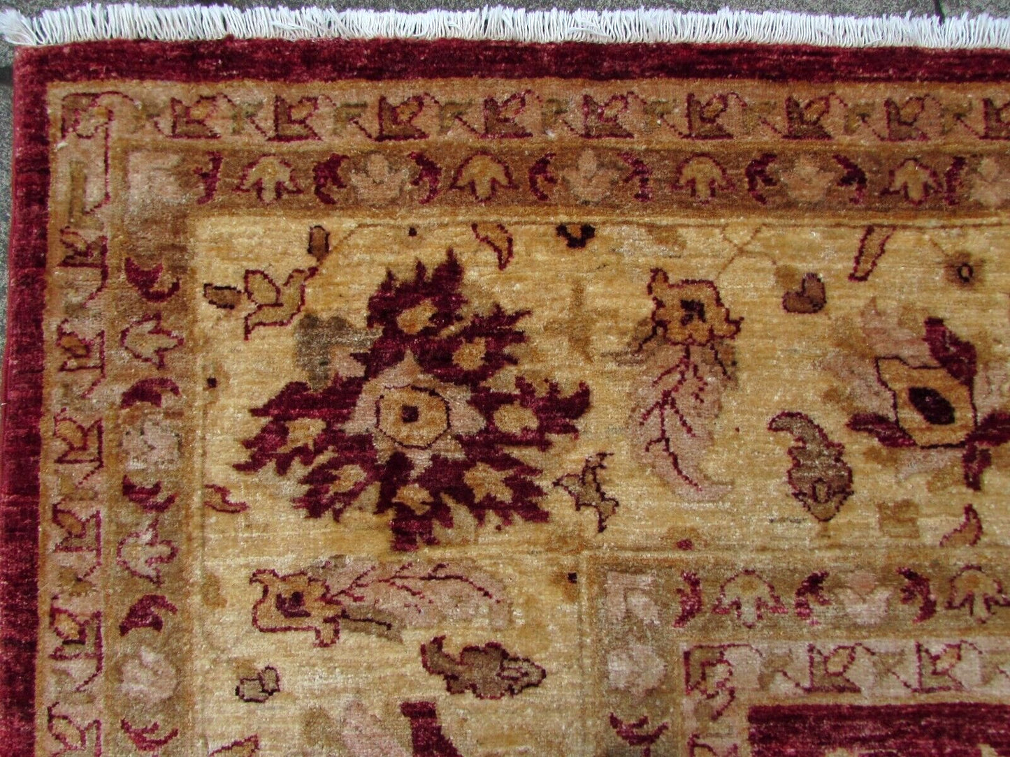 Detailed view of the ruby red background color on the rug