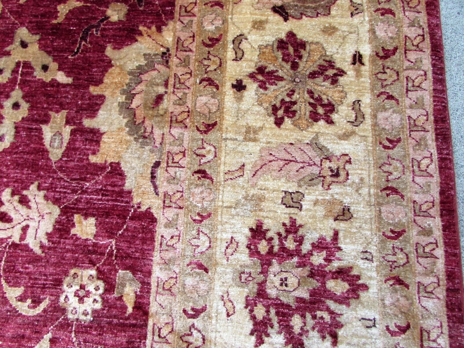 Up-close shot of the beige and olive colors in the rug's design