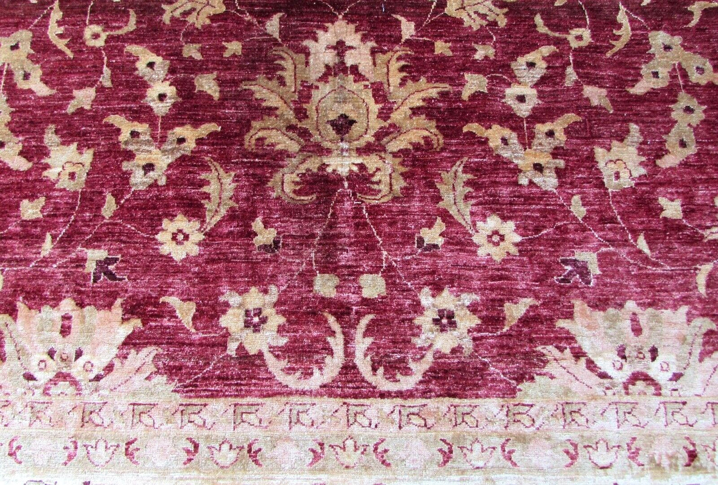 Intricate stitching of the rug's edges and corners